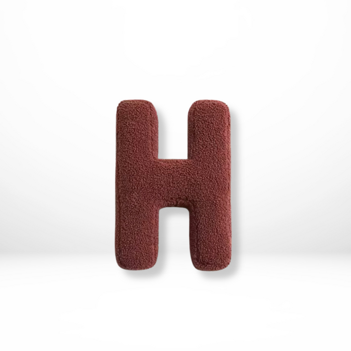 Dekorativ alfabetpude med fløjlsstruktur til boligindretning